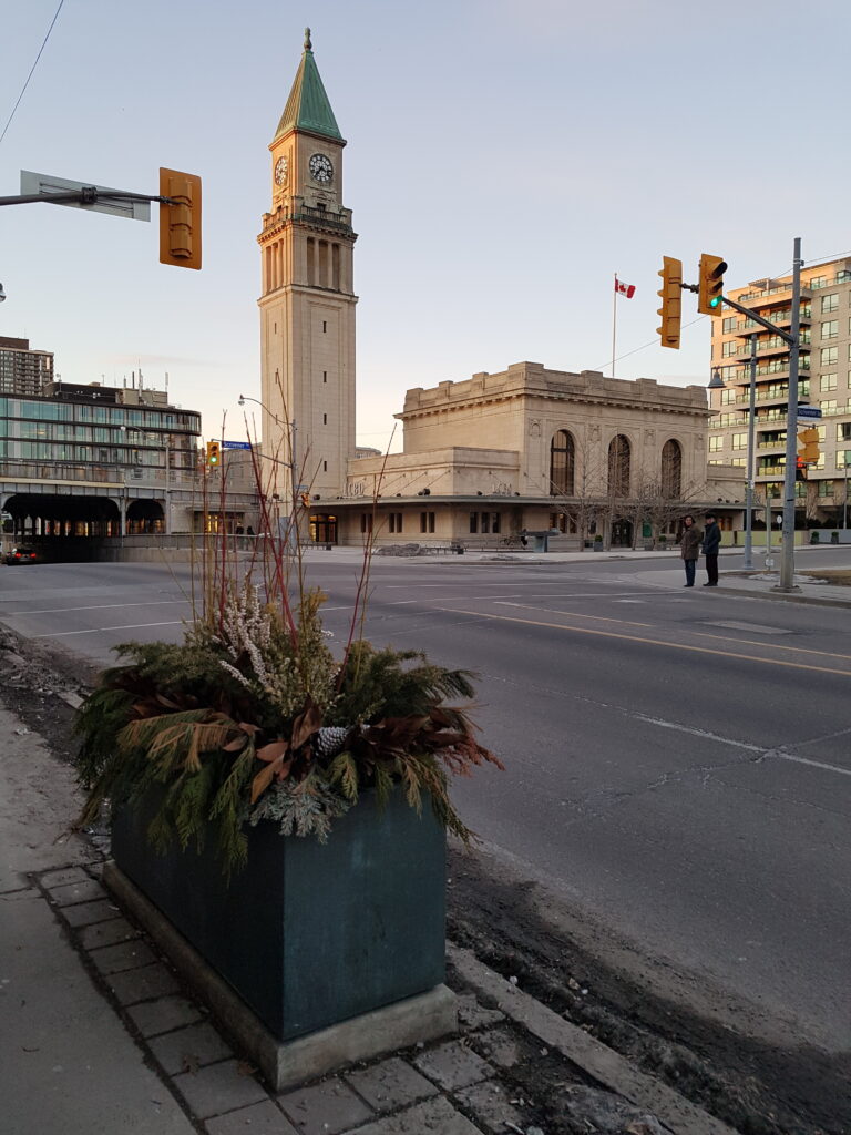 The station, clock tower, and overpass over Yonge Street is visible in this 2019 photo looking north.